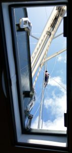 First mate being hoisted up into the mast..